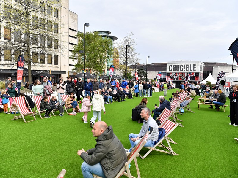 Tudor Square, in Sheffield city centre, is thronging with people, who have come to watch the snooker at The Crucible. Some people are sat on deck chairs watching the matches on a big screen.