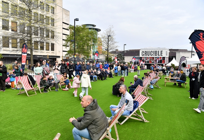 Tudor Square, in Sheffield city centre, is thronging with people, who have come to watch the snooker at The Crucible. Some people are sat on deck chairs watching the matches on a big screen.