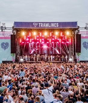 Tramlines Festival in 2019, showing the stage in the distance with a huge crowd enjoying the show.