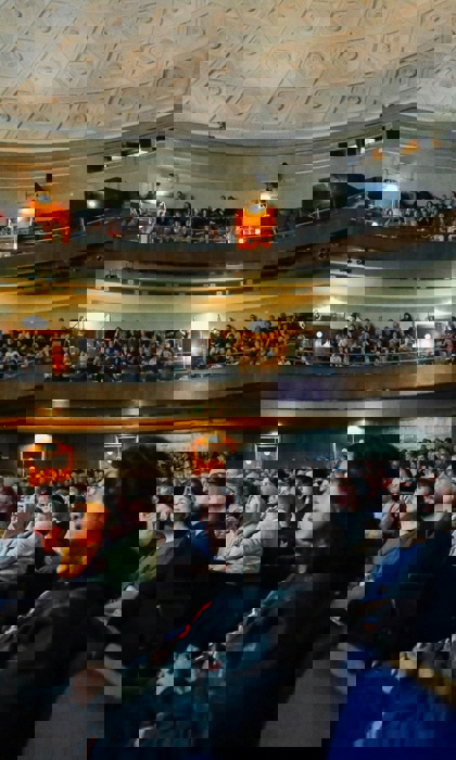 An audience inside the Oval Hall at The City Hall in Sheffield.