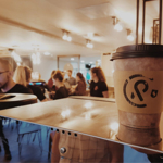 The interior of Coffee Revolution, featuring one of their disposable coffee cups.