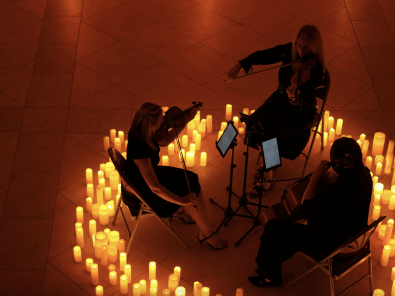 Simply Strings performing in a circle of candles.