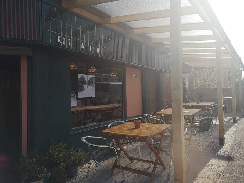 Tables set up outside at Kopi & Chai.