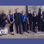 Members of Ensemble 360 stand against and old wall, holding their instruments.