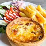 Quiche, chips and salad on a plate.
