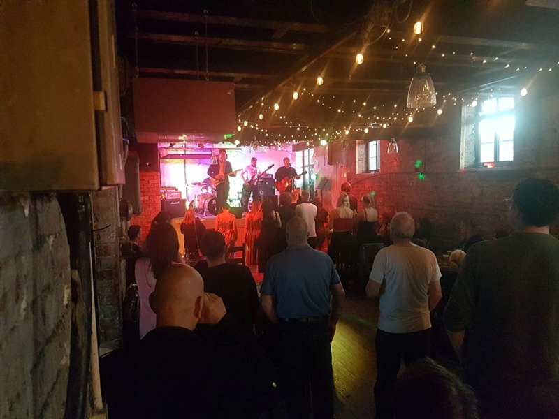 A crowd of people enjoying a night out at Toolmakers Live.