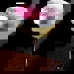 A yellow cocktails with a pink dusting on top.