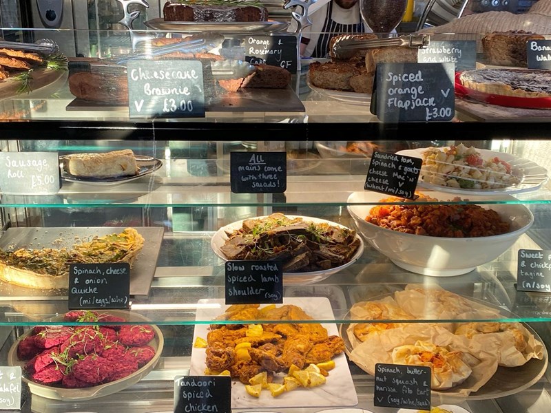 The glass counter at The Grind Café, filled with food.