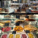 The glass counter at The Grind Café, filled with food.