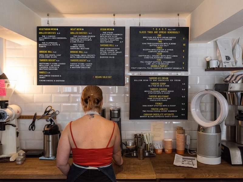 A woman prepares a coffee at Steam Yard.