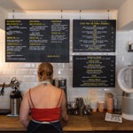 A woman prepares a coffee at Steam Yard.