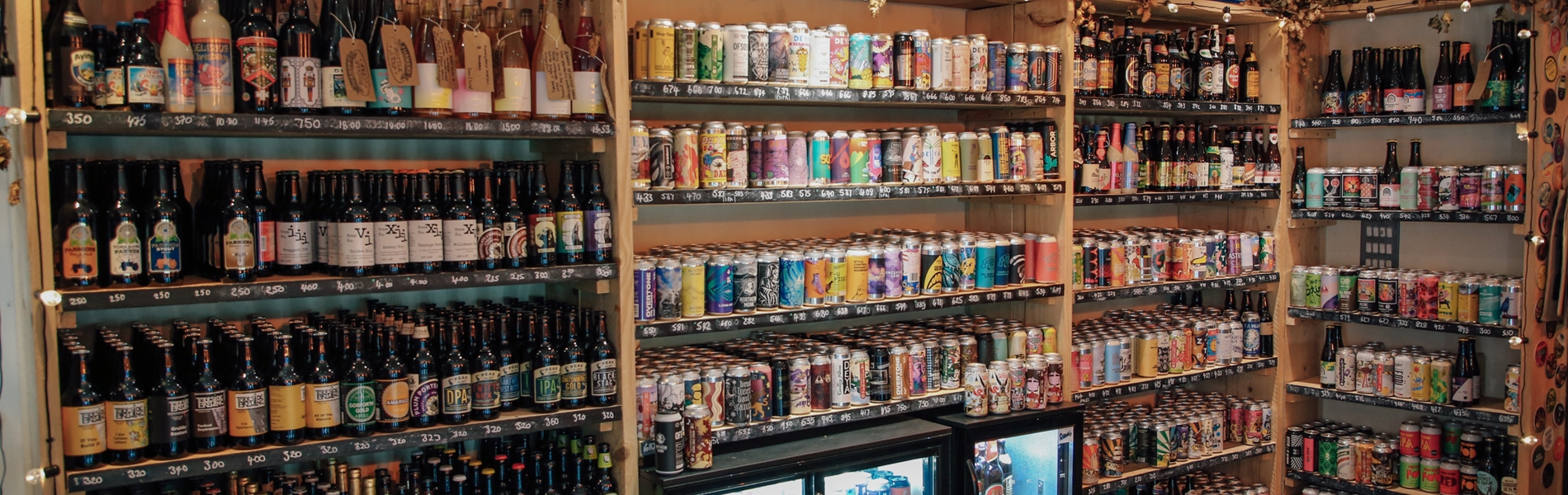 Inside Turner's Bottle Shop & Tap, the walls are taken up with shelving and chiller cabinets, all filled with bottles and cans.