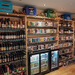 Inside Turner's Bottle Shop & Tap, the walls are taken up with shelving and chiller cabinets, all filled with bottles and cans.