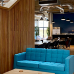 An interior shot of Cobo showing a wooden partition and a blue sofa and a low coffee table.