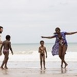 A still from the film Mother & Son, showing four of the main characters on the beach by the sea.