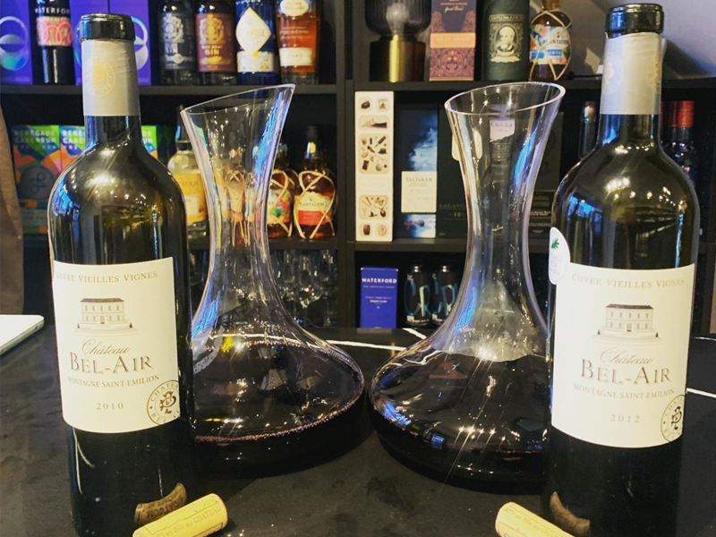 Wine bottles and carafes of wine set out on a table at Gills & Co.