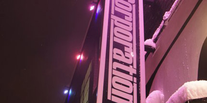 The Corporation sign on the side of the building.