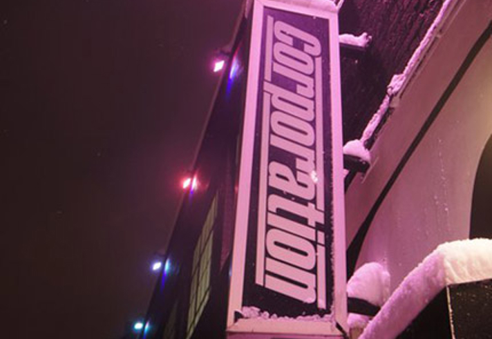 The Corporation sign on the side of the building.