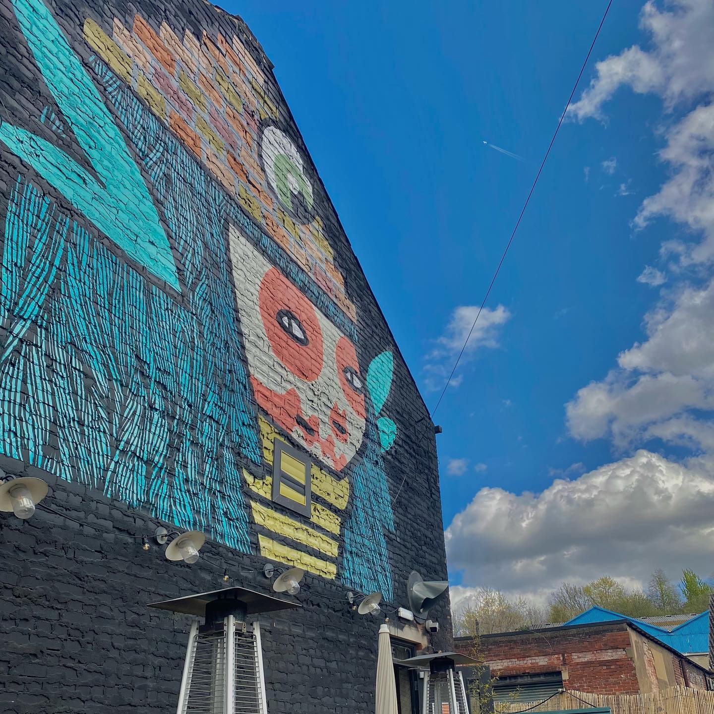 Details of the exterior of Piña, with a piece of art by Kid Acne.