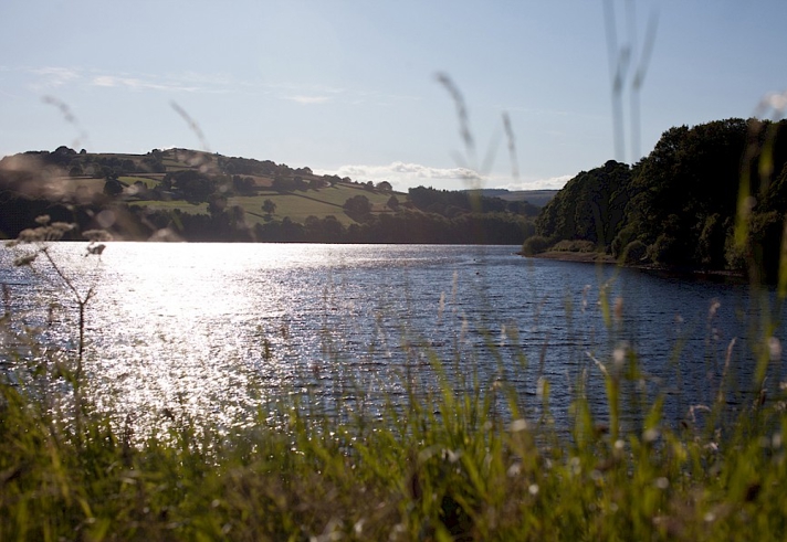 Bradfield Reservoir with the sun glinting off the water. 