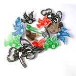 Collection of colorful bird-shaped brooches in red, green, blue, black, and metallic tones with intricate floral and leaf patterns, arranged on a white background.