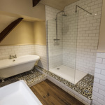 Modern bathroom in a Losehill Hall Hotel guest room with sleek fixtures and a clean design with bath and walk-in shower.