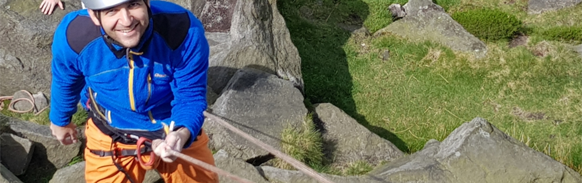 A person learning rock climbing.