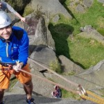A person learning rock climbing.