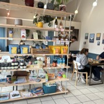 A photo of the inside of the cafe, with some of the stuff stocked up on shelves