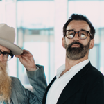 Three men, all with beards and glasses.