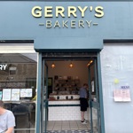A photo of outside the the bakery, with the sign on top that reads Gerry's Bakery in gold letters