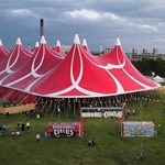 The Rock N Roll Circus seen from the air, dominated by the huge, red circus tent.