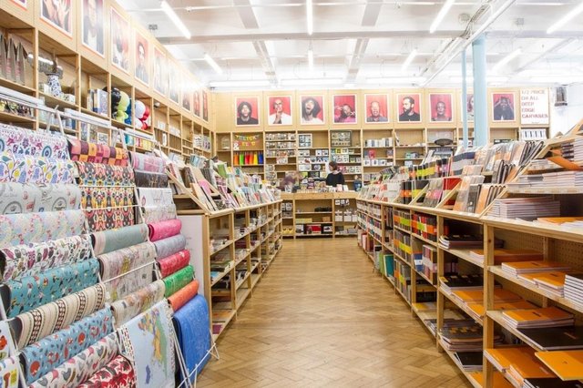 Inside the Fred Aldous Sheffield shop. There are rows of display units filled with art supplies.