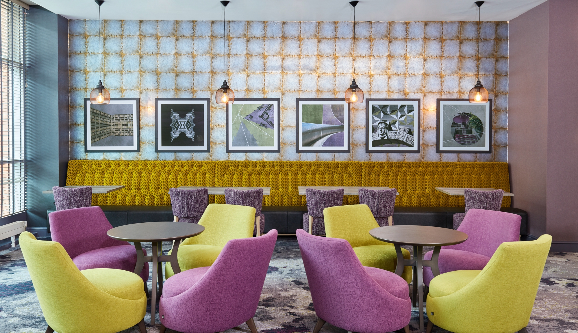 A bar area in a hotel with bright, modern furnishings.