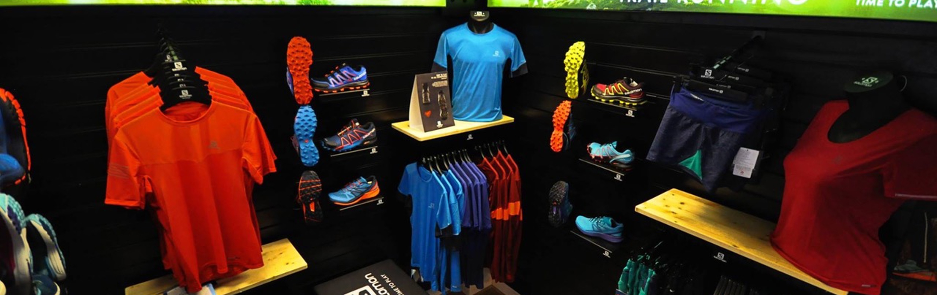 Inside the myRaceKit North shop, with lots of shelves and clothes rails full of running shoes and clothing.