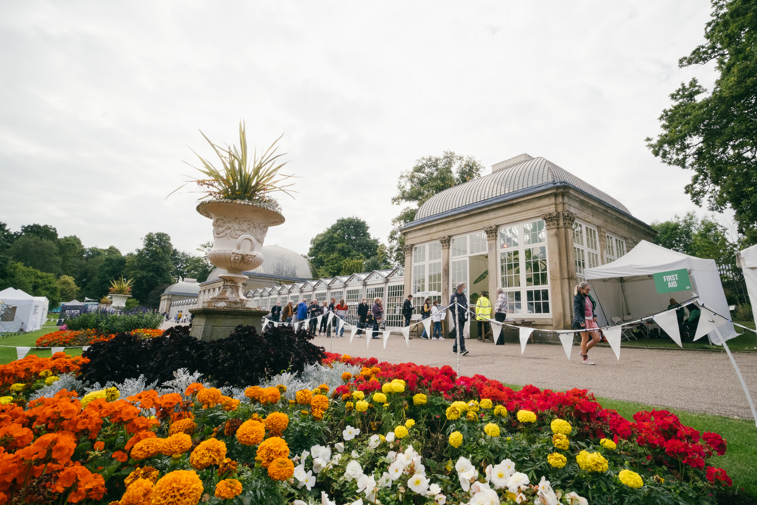 Flower beds in bloom in front of the Glass House at Sheffield Botanical Gardens.