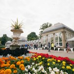 Flower beds in bloom in front of the Glass House at Sheffield Botanical Gardens.