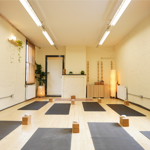 A brightly lit room at Ting Studio with mats laid out on the floor.
