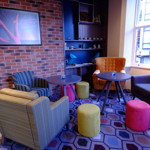 A waiting area at Curzon Sheffield, with armchairs and coffee tables.