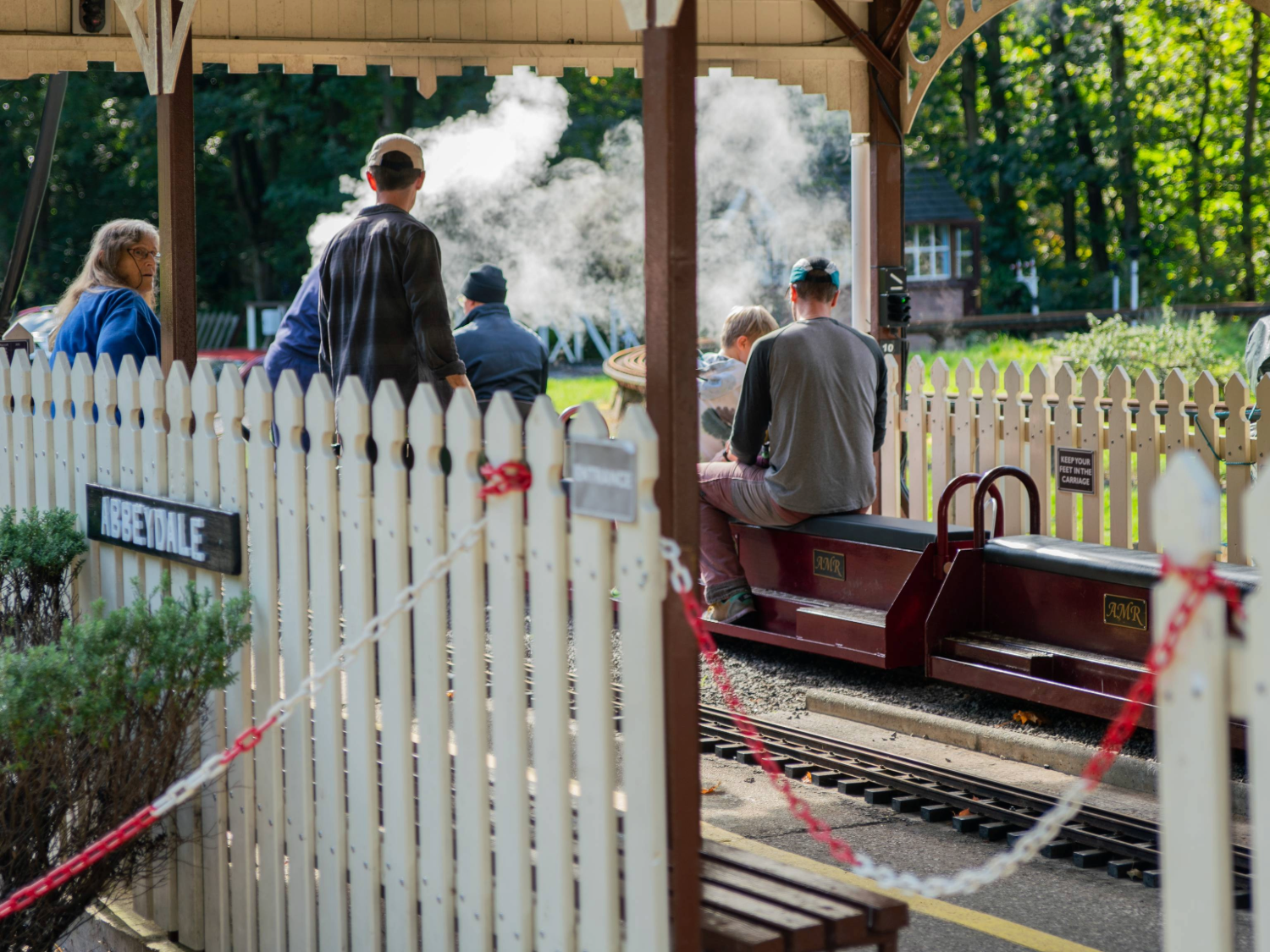A family rides on a miniature steam train at the Abbeydale Miniature Railway in Sheffield.