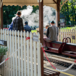 A family rides on a miniature steam train at the Abbeydale Miniature Railway in Sheffield.