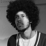 A black and white photo of a young man.