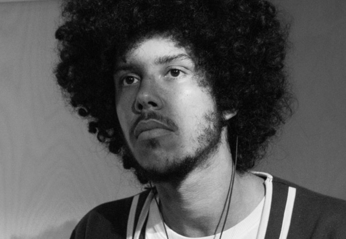 A black and white photo of a young man.