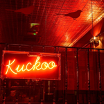 A red neon sign that reads 'Kuckoo'.