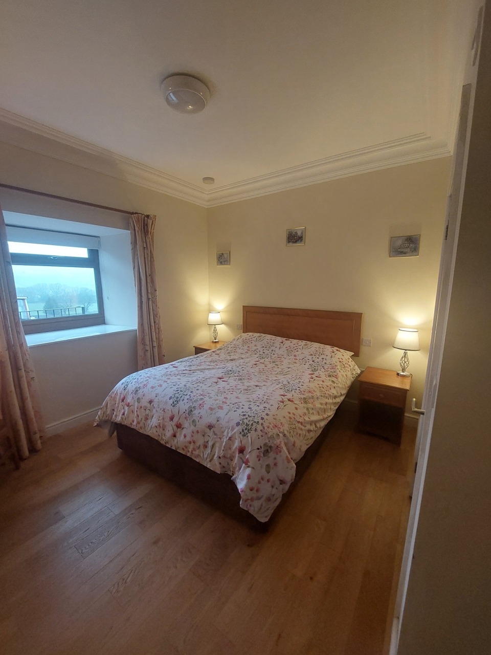 Padley Farm - bedroom with bed, bedside table, and simple furnishings.