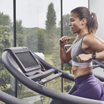 A woman on a running machine in a gym.