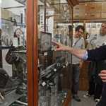 A group of people having a guided tour around The Alfred Denny Museum Of Zoology.