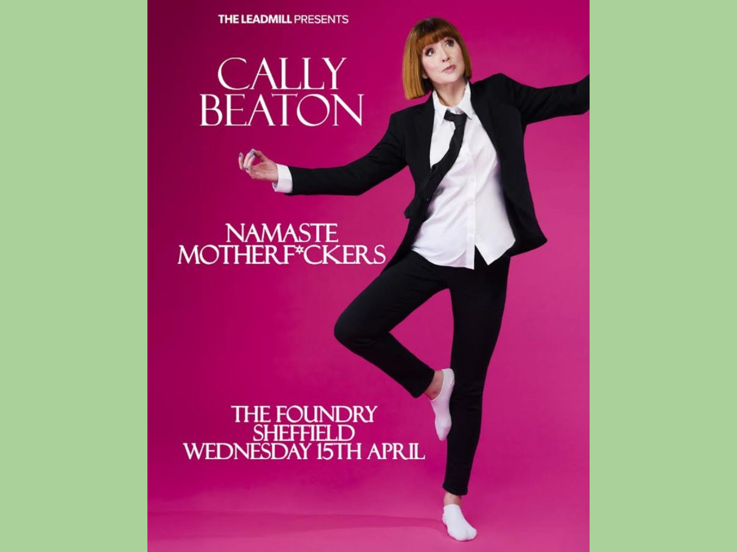 Poster for Cally Beaton: Namaste Motherf*ckers at the Foundry featuring a picture of Cally Beaton in a black suite and tie with a white shirt, standing on one leg in her socked feet.