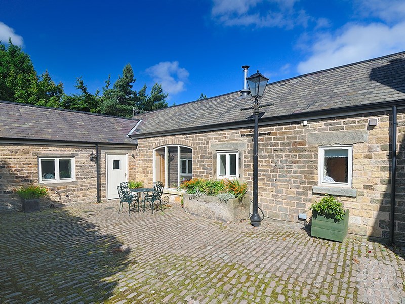 Exterior of Gooseberry Farm Cottages showing traditional stone buildings