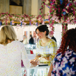 Groups of people looking at displays of jewellery.